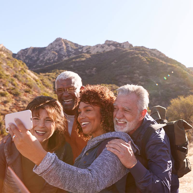 group of senior friends taking a selfie while hiking annuity for retirement